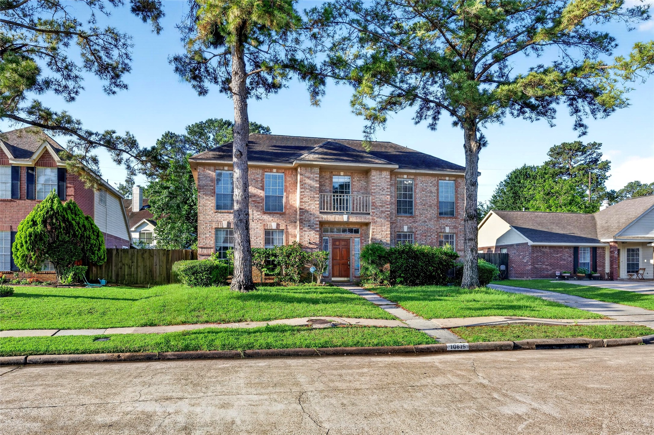 10615 Vandercroft Court Houston, TX 77070 - Photo 4 of 47 a view of a white house with a big yard plants and large trees