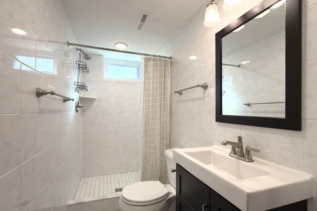 a bathroom with a sink toilet and shower