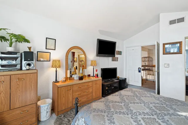 a view of a workspace with furniture and a flat screen tv