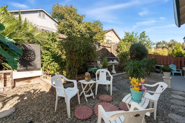 a view of a patio with a table and chairs under an umbrella
