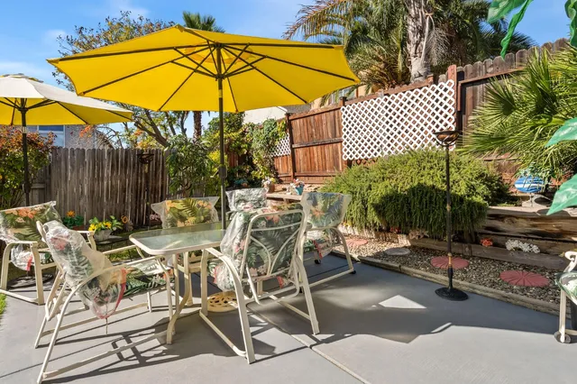 a view of a swimming pool with a table and chairs