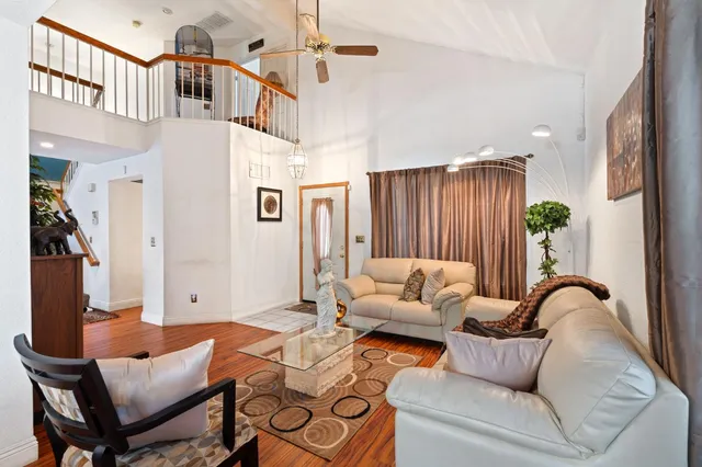 a living room with furniture a fireplace and a chandelier