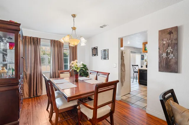 a dining room with furniture window and wooden floor