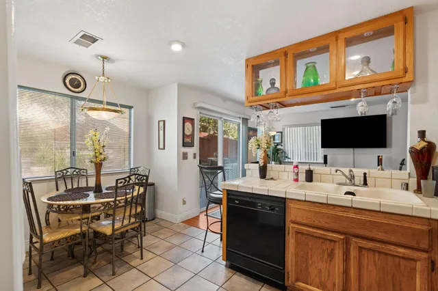 a room with stainless steel appliances kitchen island granite countertop a sink and cabinets