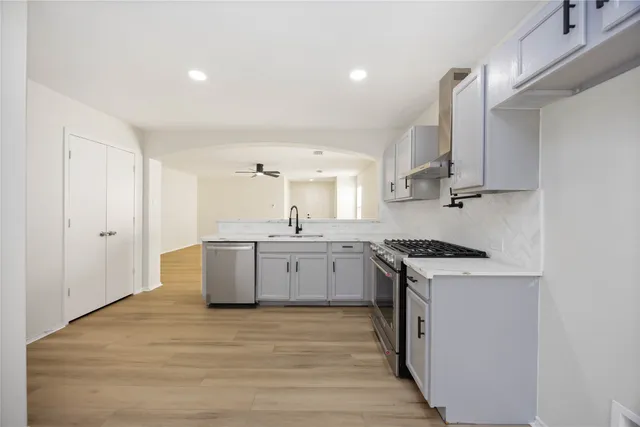 a kitchen with a stove top oven sink and cabinets