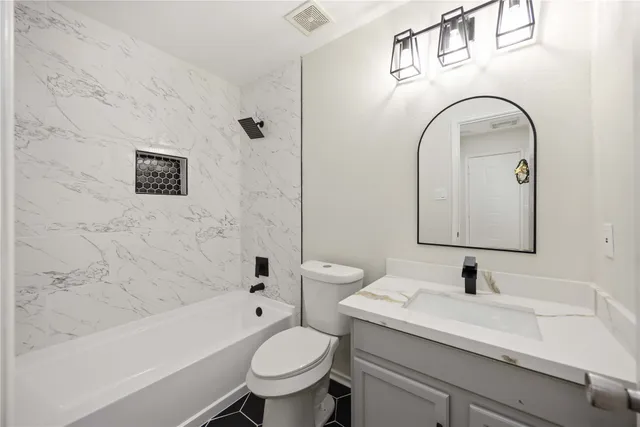 a bathroom with a sink a toilet and a bathtub