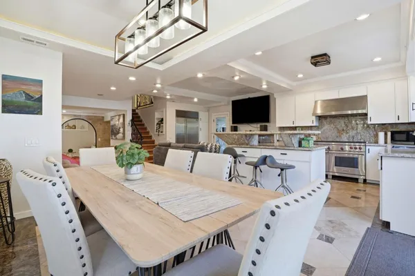 a large kitchen with a table and chairs