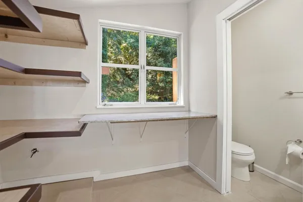 a bathroom with a toilet sink and window