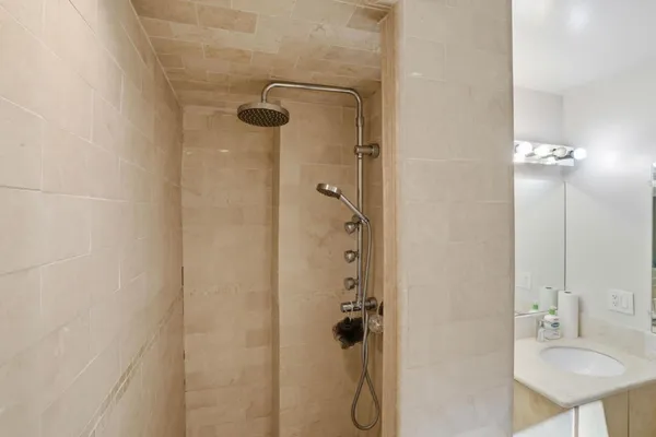 a bathroom with a shower and a sink