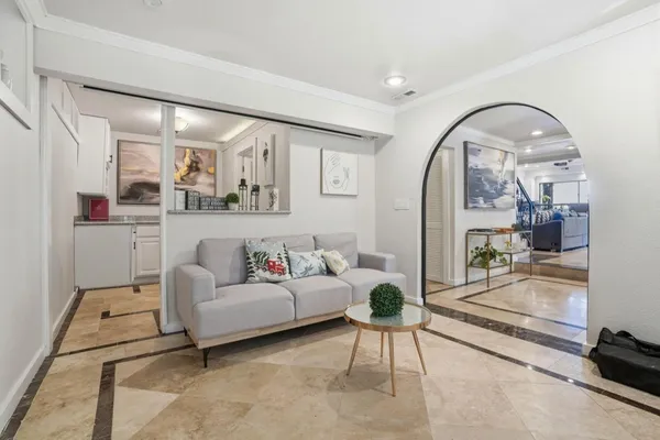 a living room with furniture and a painting on the wall