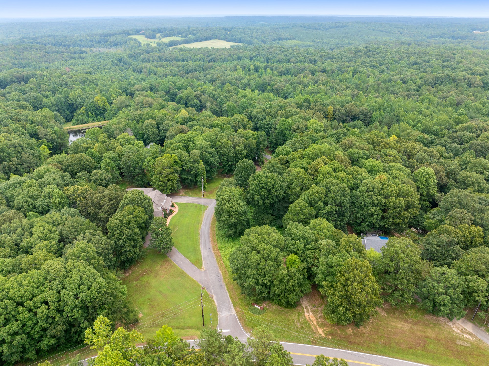 an aerial view of a houses with a yard
