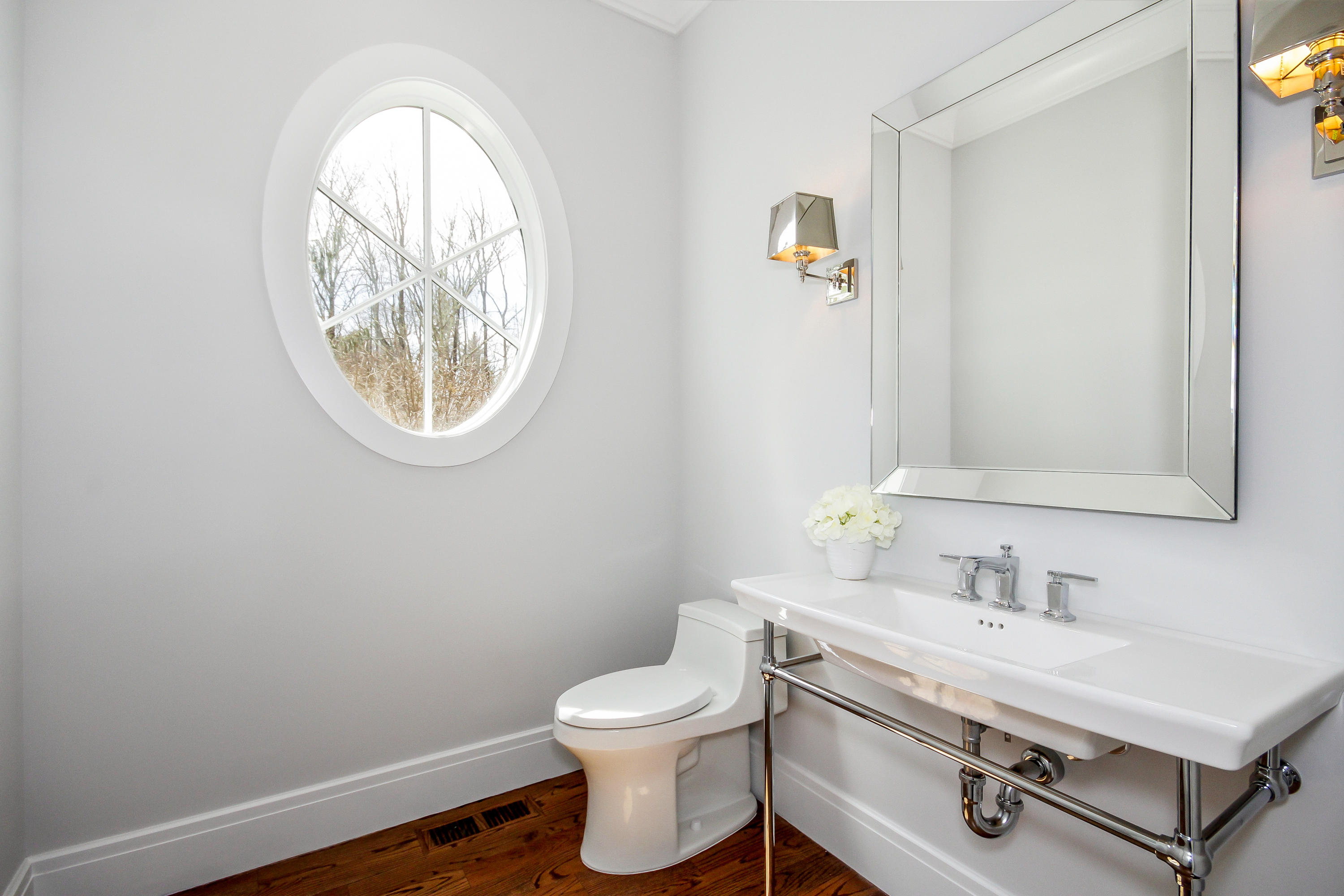 134 Lambert Road New Canaan, CT 06840 - Photo 19 of 50 a bathroom with a toilet a sink and mirror
