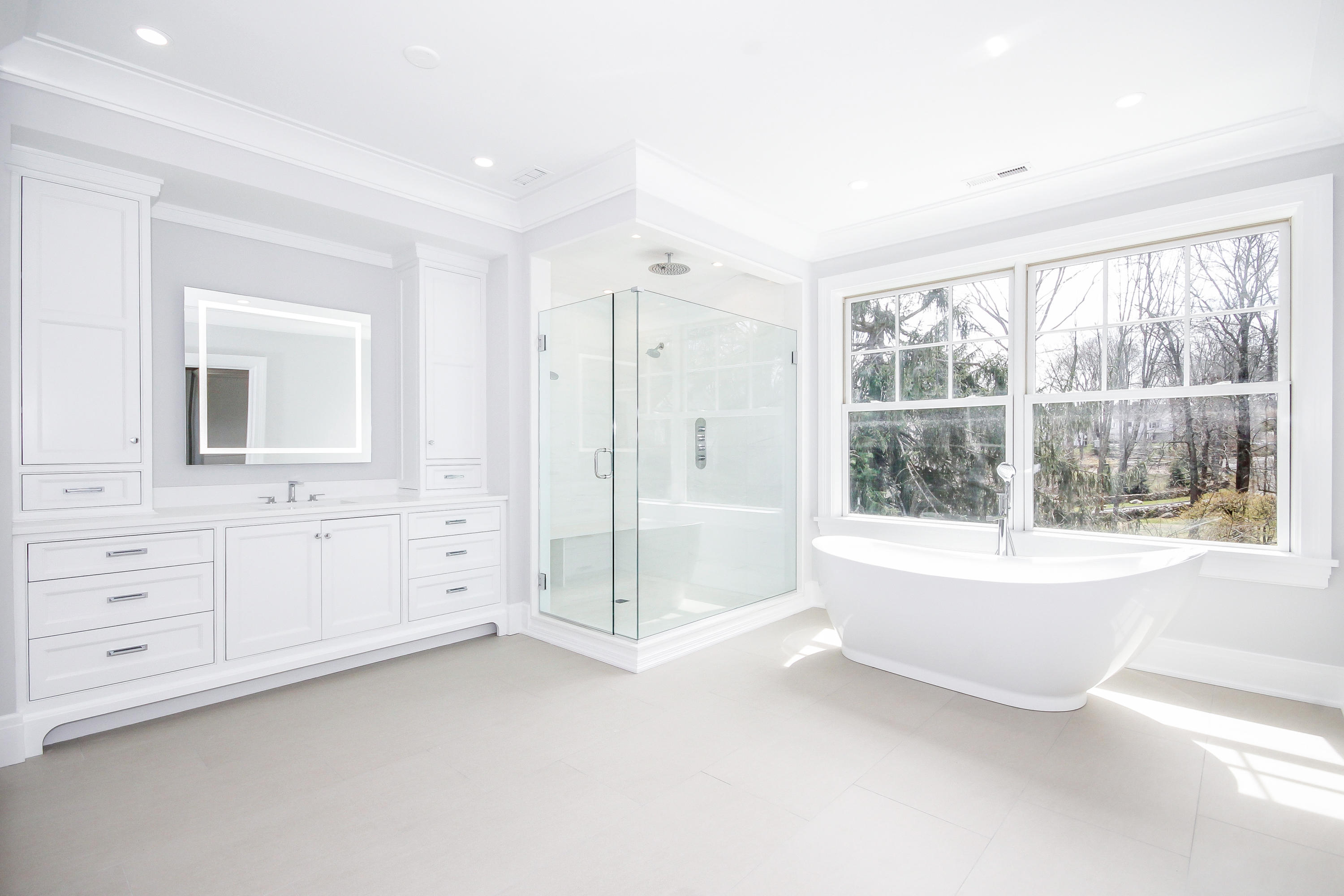 134 Lambert Road New Canaan, CT 06840 - Photo 29 of 50 a bathroom with a tub sink and mirror