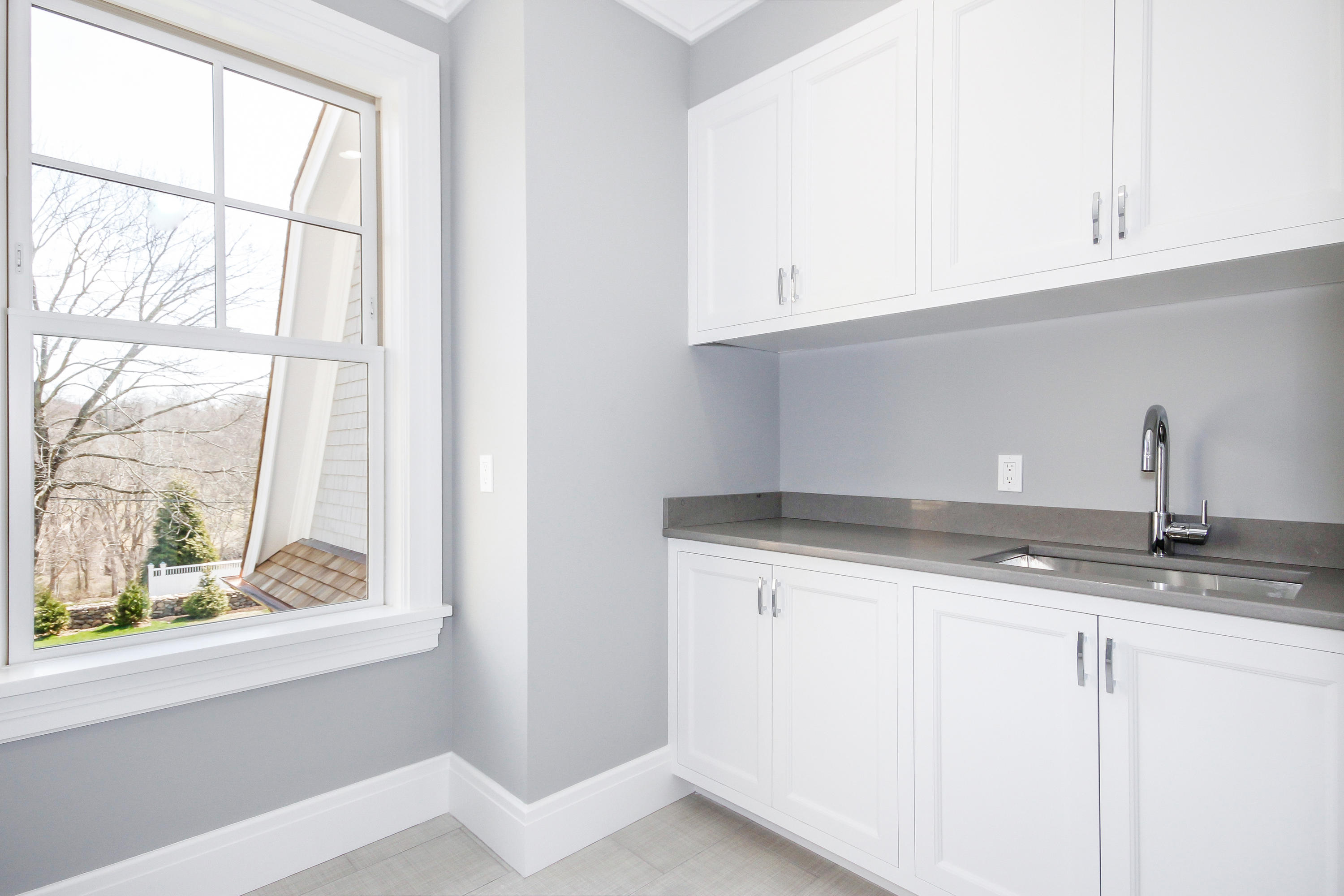 134 Lambert Road New Canaan, CT 06840 - Photo 36 of 50 a kitchen with granite countertop a sink and a window