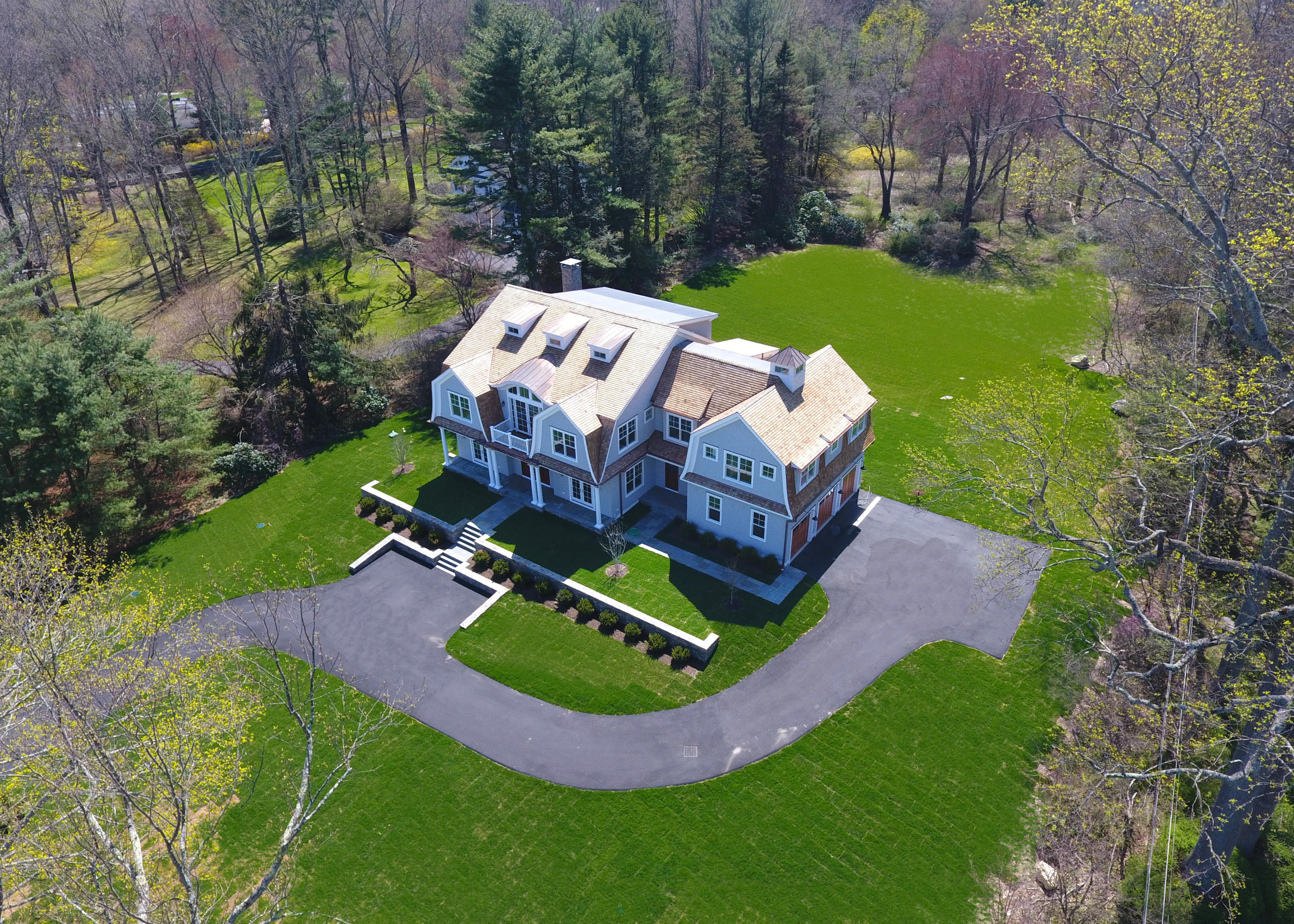 134 Lambert Road New Canaan, CT 06840 - Photo 47 of 50 an aerial view of a house with garden space pool seating area and yard