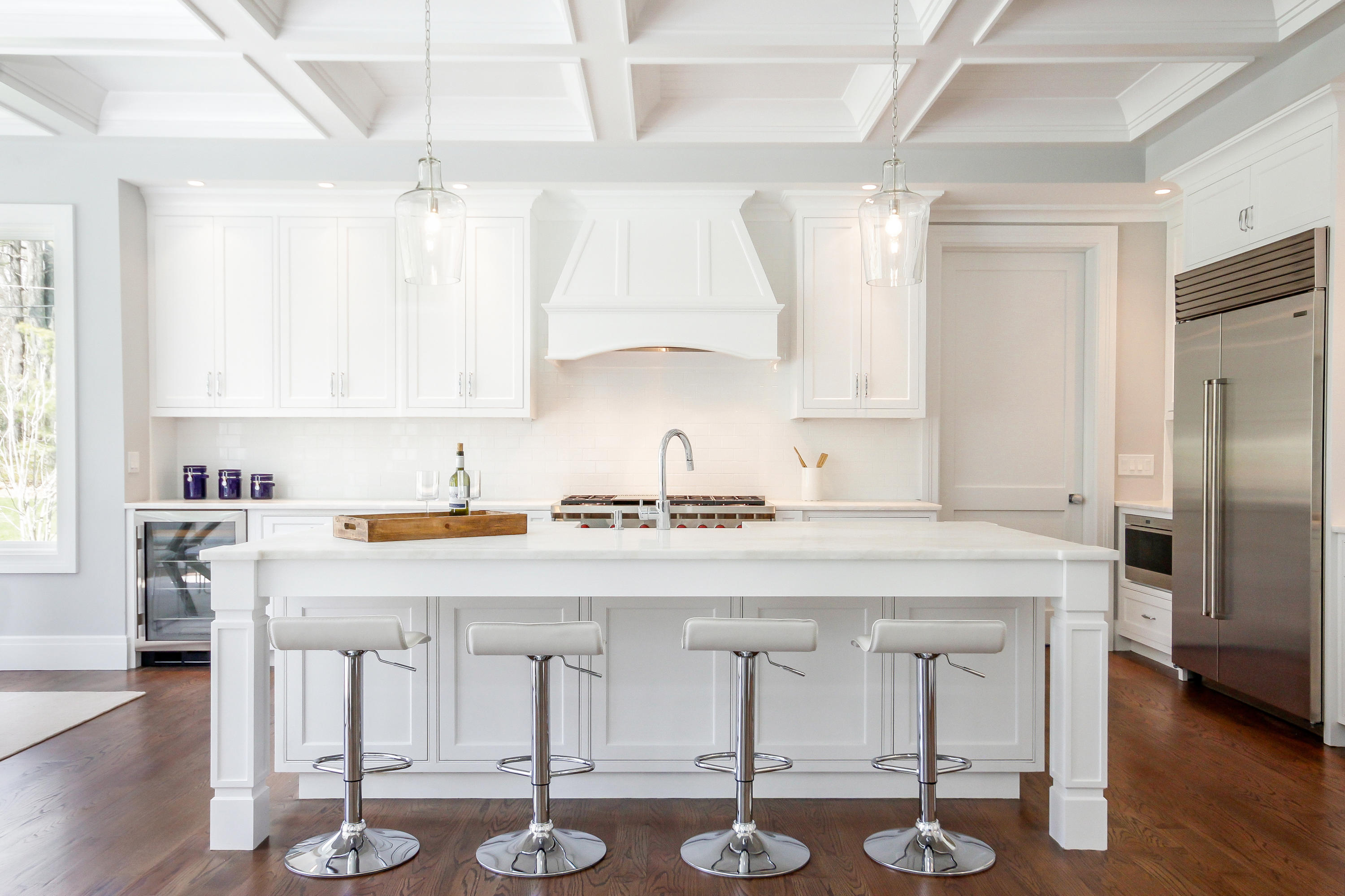 134 Lambert Road New Canaan, CT 06840 - Photo 10 of 50 a kitchen with kitchen island granite countertop a sink a stove and chairs