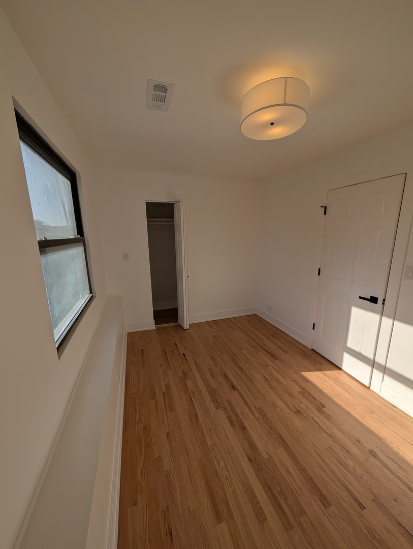 916 North Noble Street, Unit 2F Chicago, IL 60642 - Photo 11 of 22 a view of empty room with wooden floor