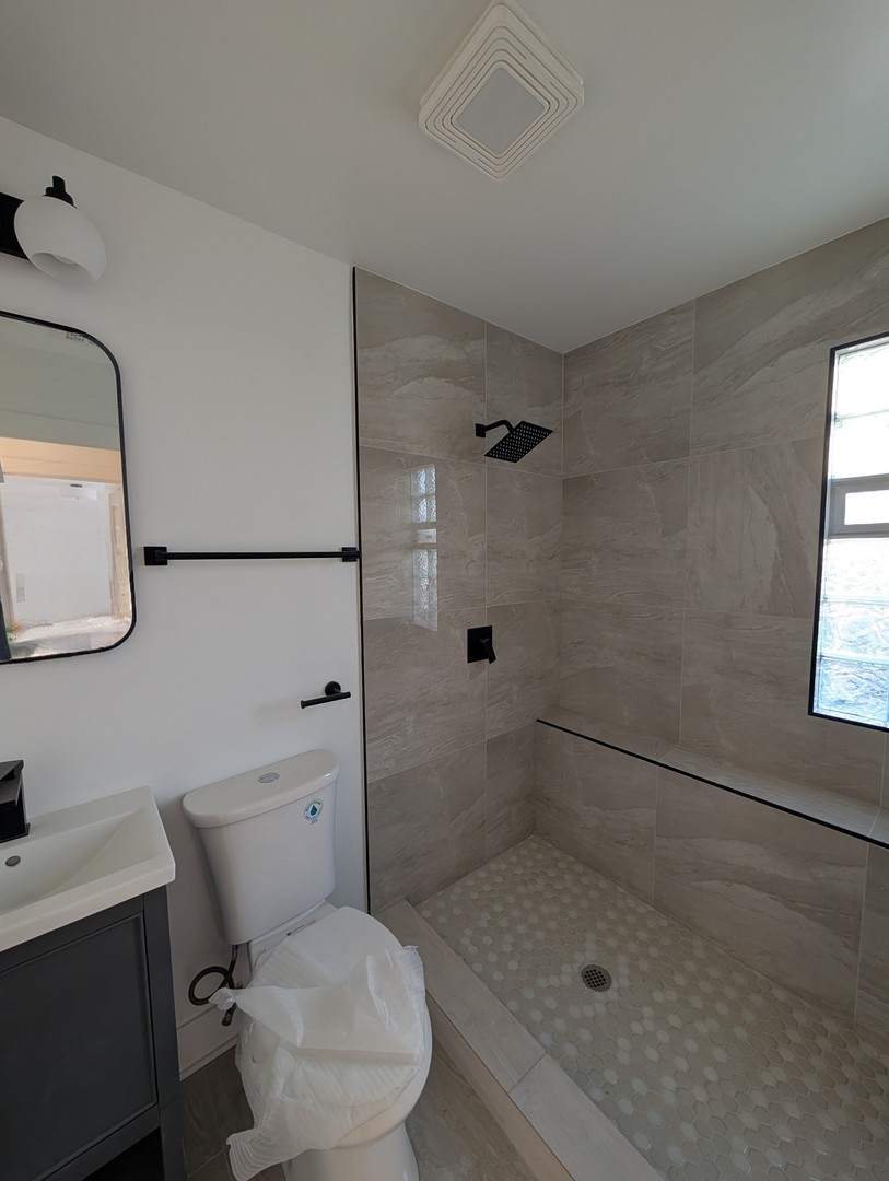 916 North Noble Street, Unit 2F Chicago, IL 60642 - Photo 14 of 22 a bathroom with a granite countertop toilet sink and shower