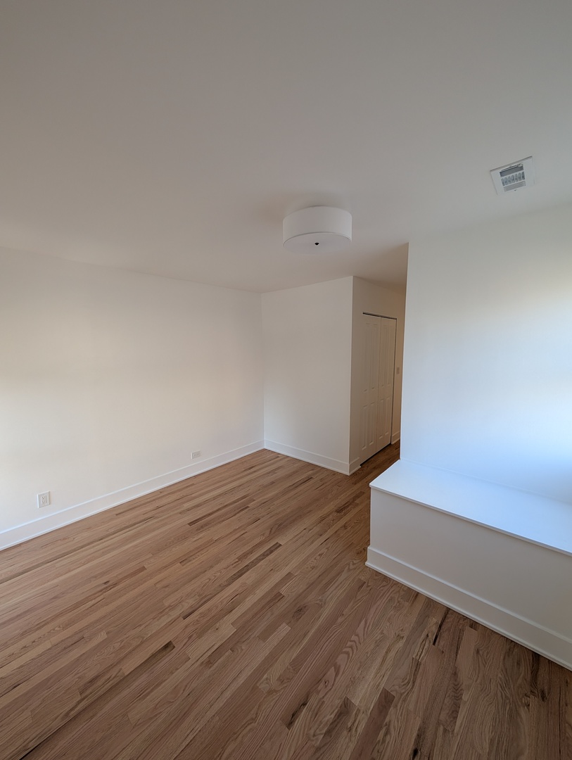 916 North Noble Street, Unit 2F Chicago, IL 60642 - Photo 16 of 22 a view of wooden floor and windows in a room
