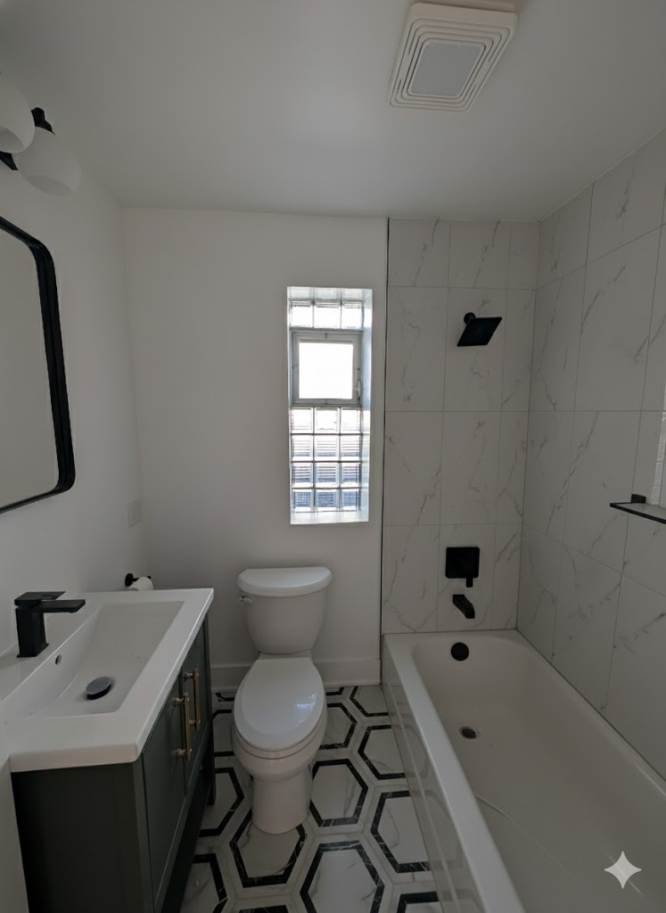 916 North Noble Street, Unit 2F Chicago, IL 60642 - Photo 20 of 22 a bathroom with a sink toilet vanity and tub