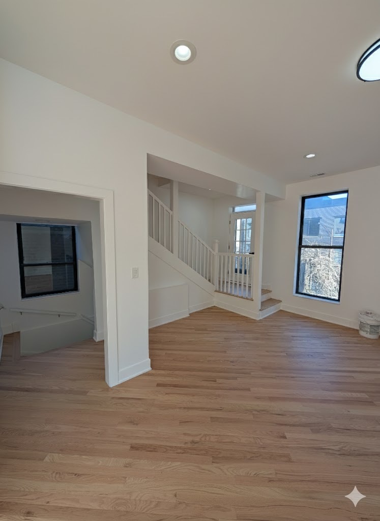 916 North Noble Street, Unit 2F Chicago, IL 60642 - Photo 2 of 22 a view of an empty room with wooden floor and kitchen