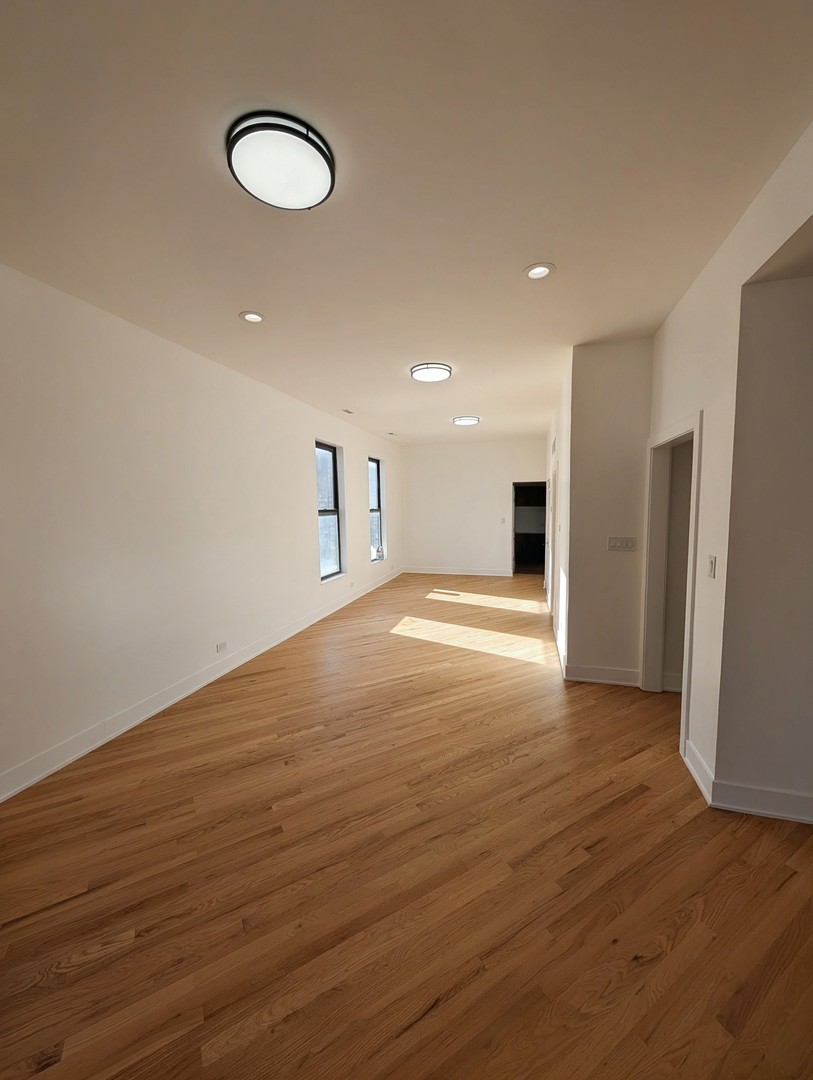 916 North Noble Street, Unit 2F Chicago, IL 60642 - Photo 3 of 22 a view of empty room with wooden floor and window