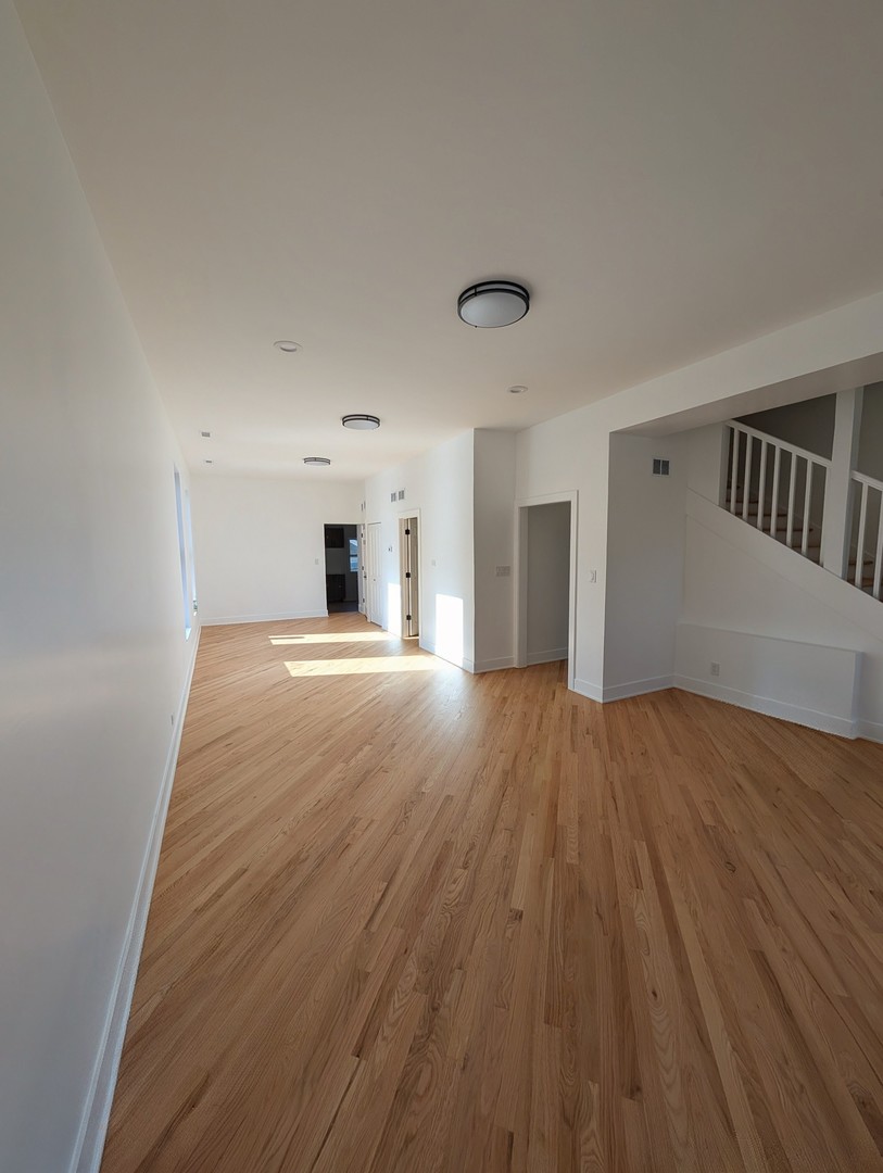 916 North Noble Street, Unit 2F Chicago, IL 60642 - Photo 6 of 22 wooden floor in an empty room with a window