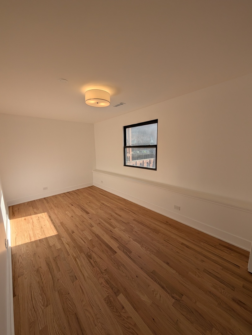 916 North Noble Street, Unit 2F Chicago, IL 60642 - Photo 9 of 22 wooden floor in an empty room