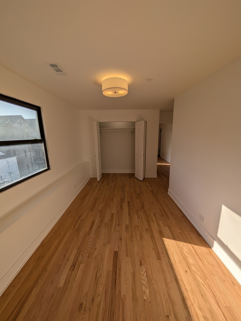916 North Noble Street, Unit 2F Chicago, IL 60642 - Photo 10 of 22 a view of a room with wooden floor and small space