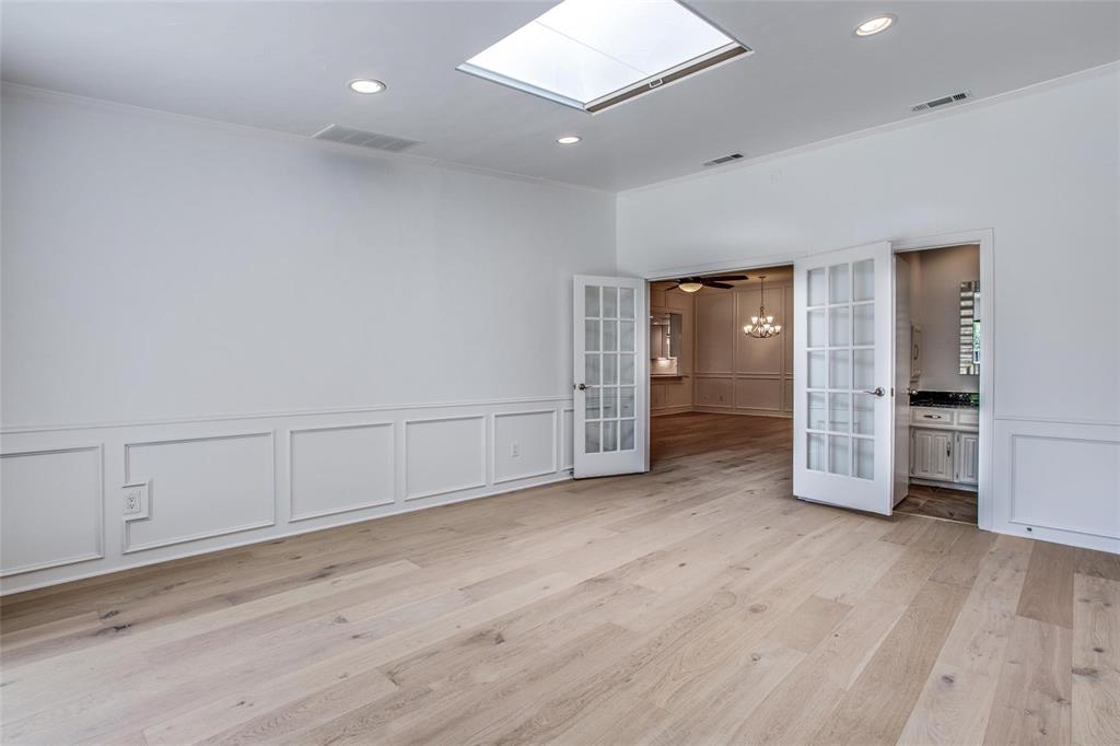 6926 Northwood Road Dallas, TX 75225 - Photo 19 of 29 an empty room with wooden floor and closet
