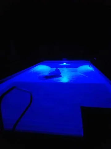 a view of a patio with table and chairs under an umbrella