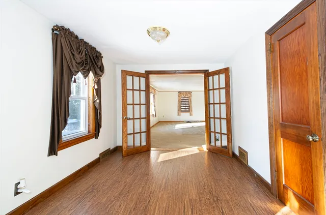 a view of hallway with wooden floor and stairs