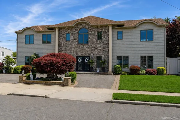 a front view of house with yard and green space