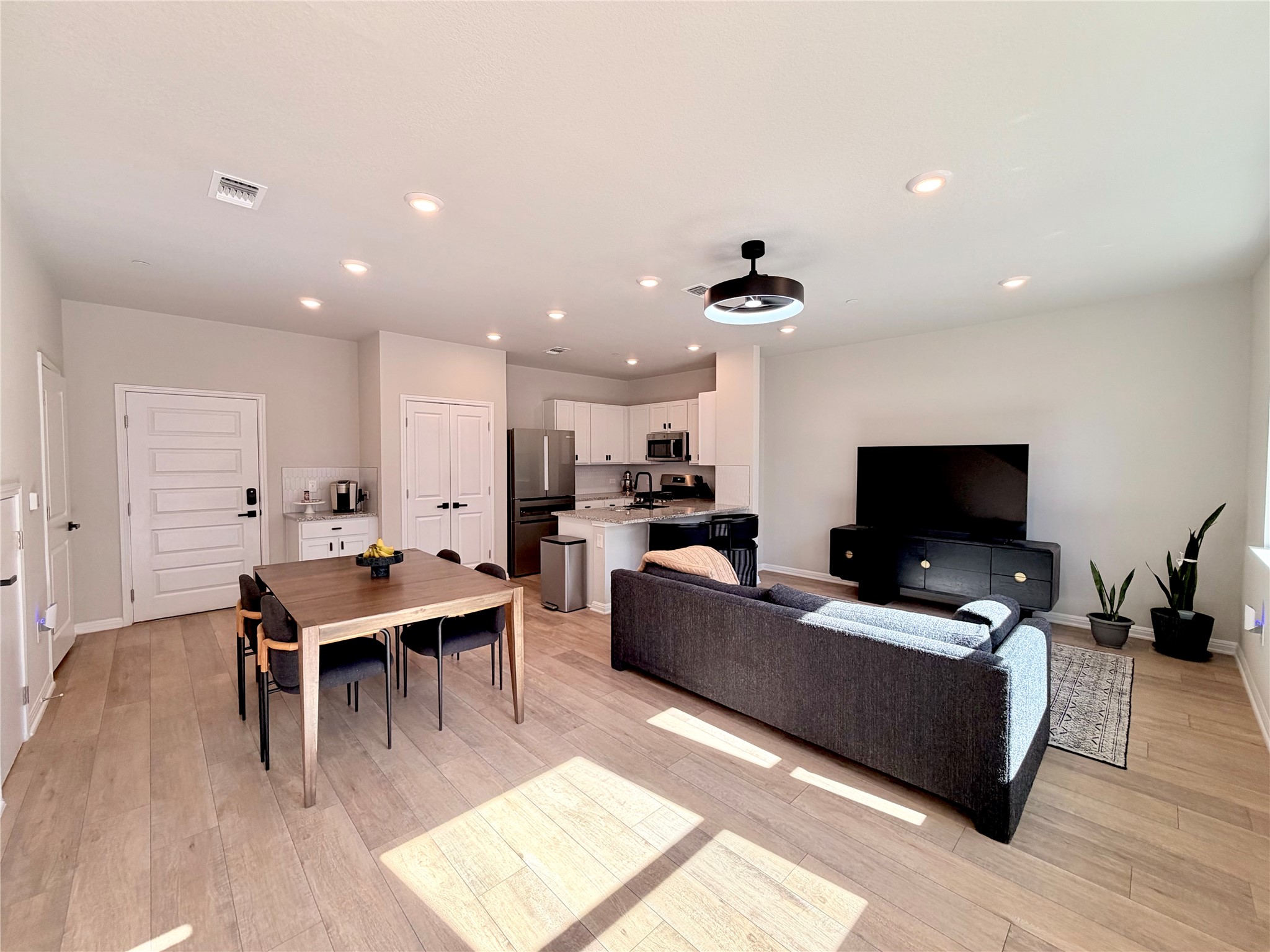 Open concept Living area with recessed lighting and light wood-style floors