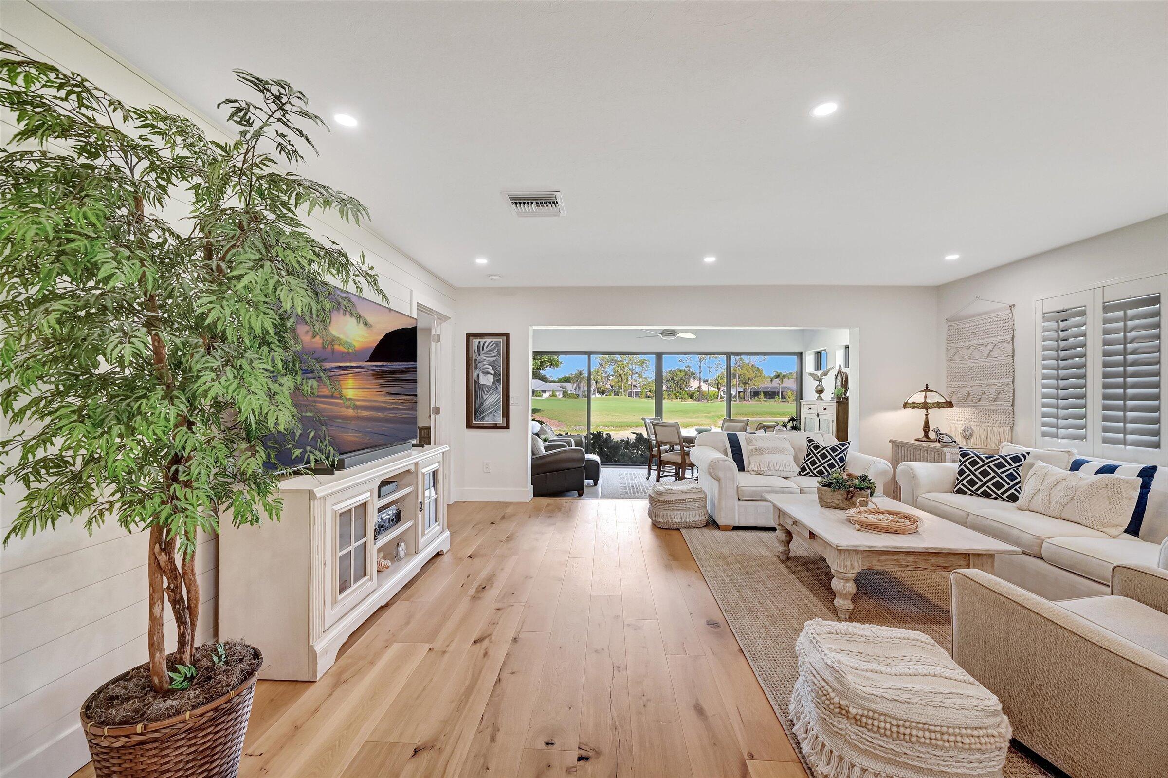 535 Augusta Boulevard, Unit 4 Naples, FL 34113 - Photo 12 of 44 a living room with furniture a flat screen tv and a large window