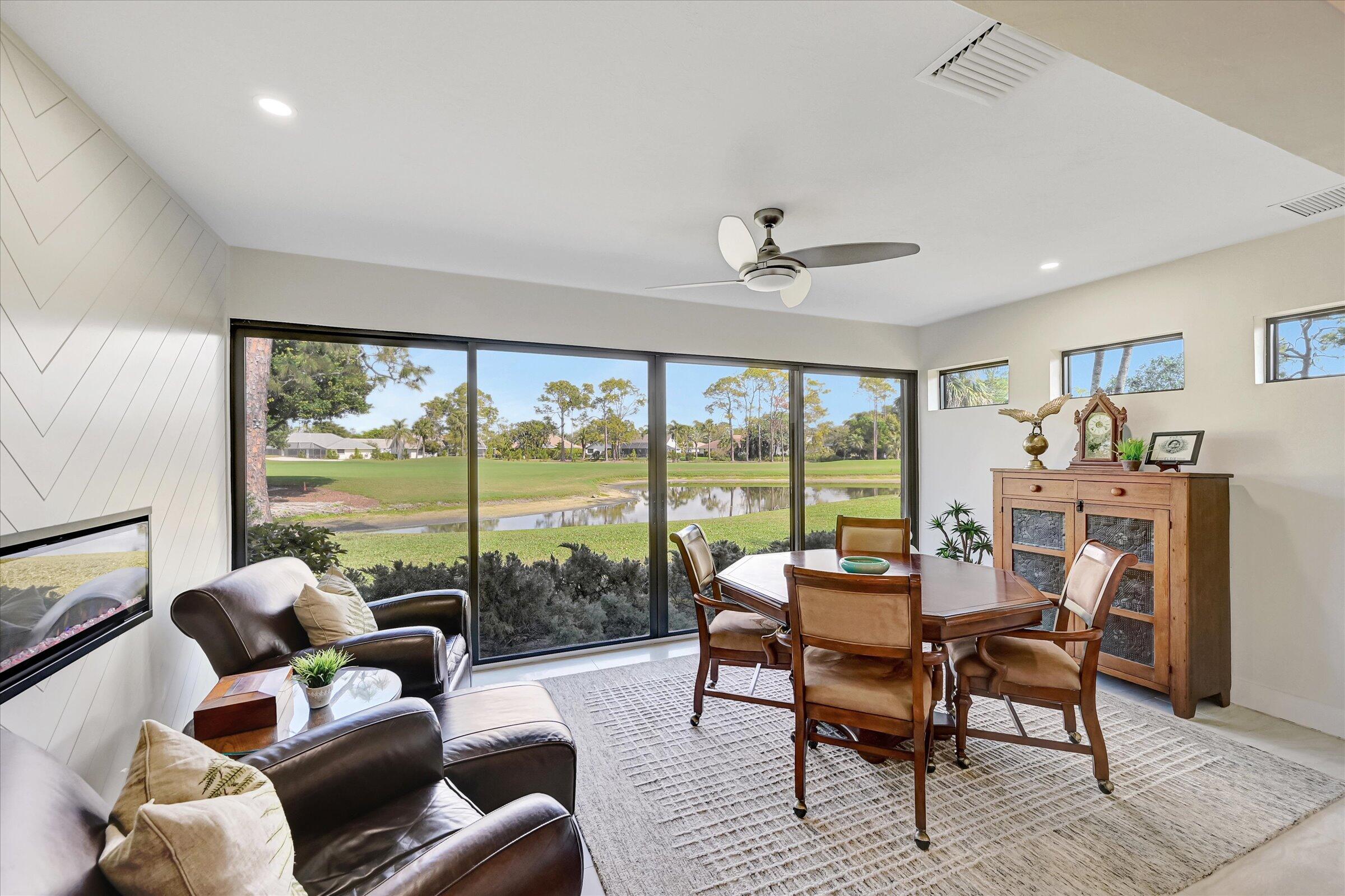 535 Augusta Boulevard, Unit 4 Naples, FL 34113 - Photo 26 of 44 a living room with furniture and a large window