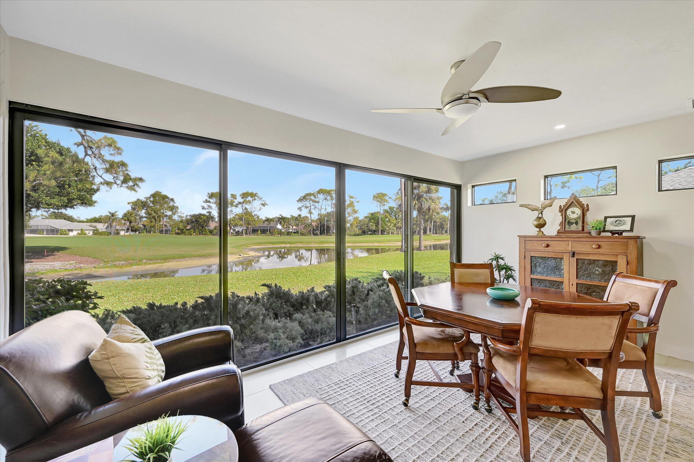 535 Augusta Boulevard, Unit 4 Naples, FL 34113 - Photo 27 of 44 a dining room with furniture water view and a floor to ceiling window