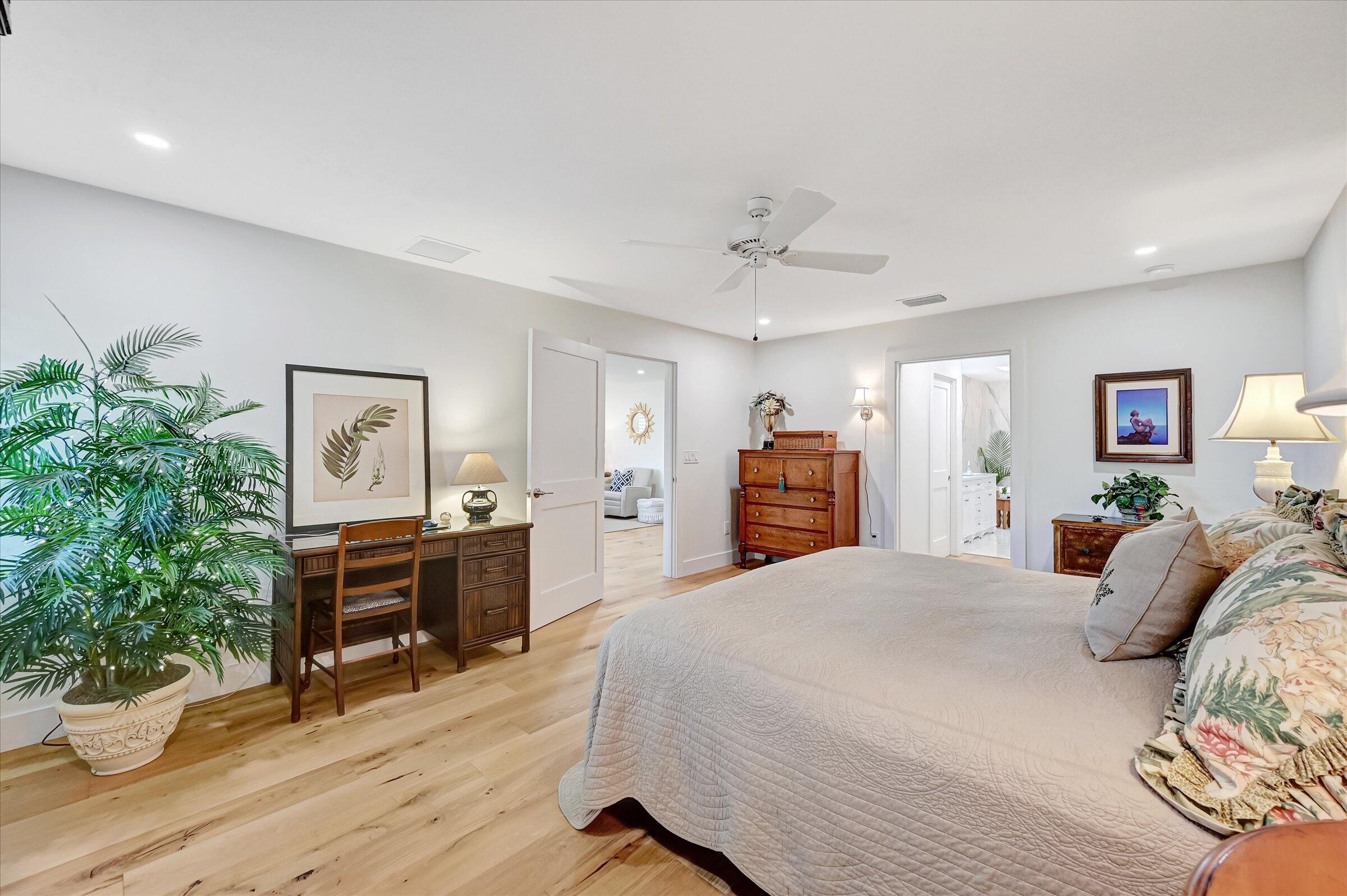 535 Augusta Boulevard, Unit 4 Naples, FL 34113 - Photo 30 of 44 a spacious bedroom with a bed and a table in it