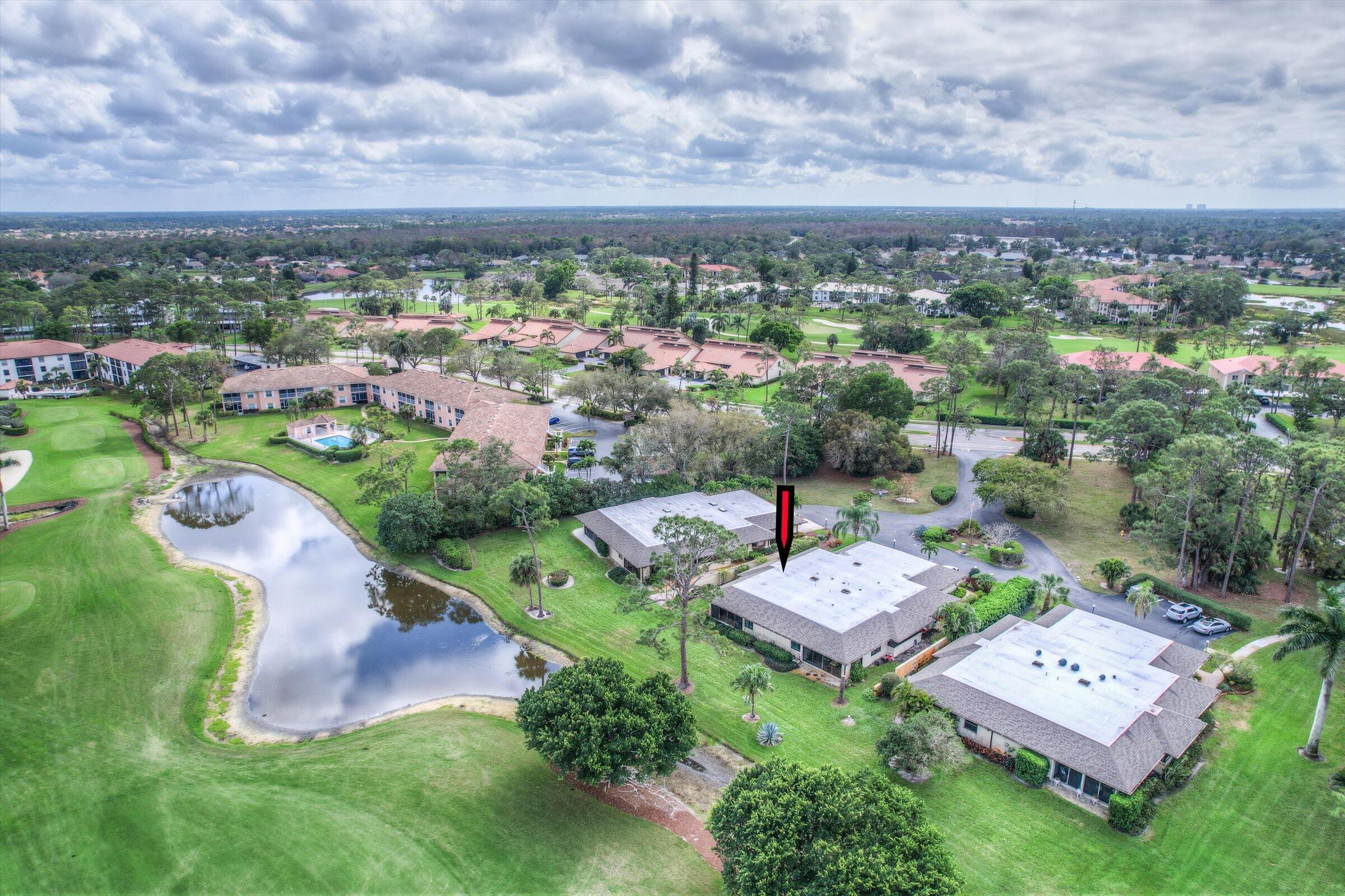 535 Augusta Boulevard, Unit 4 Naples, FL 34113 - Photo 3 of 44 an aerial view of a house with a garden and lake view