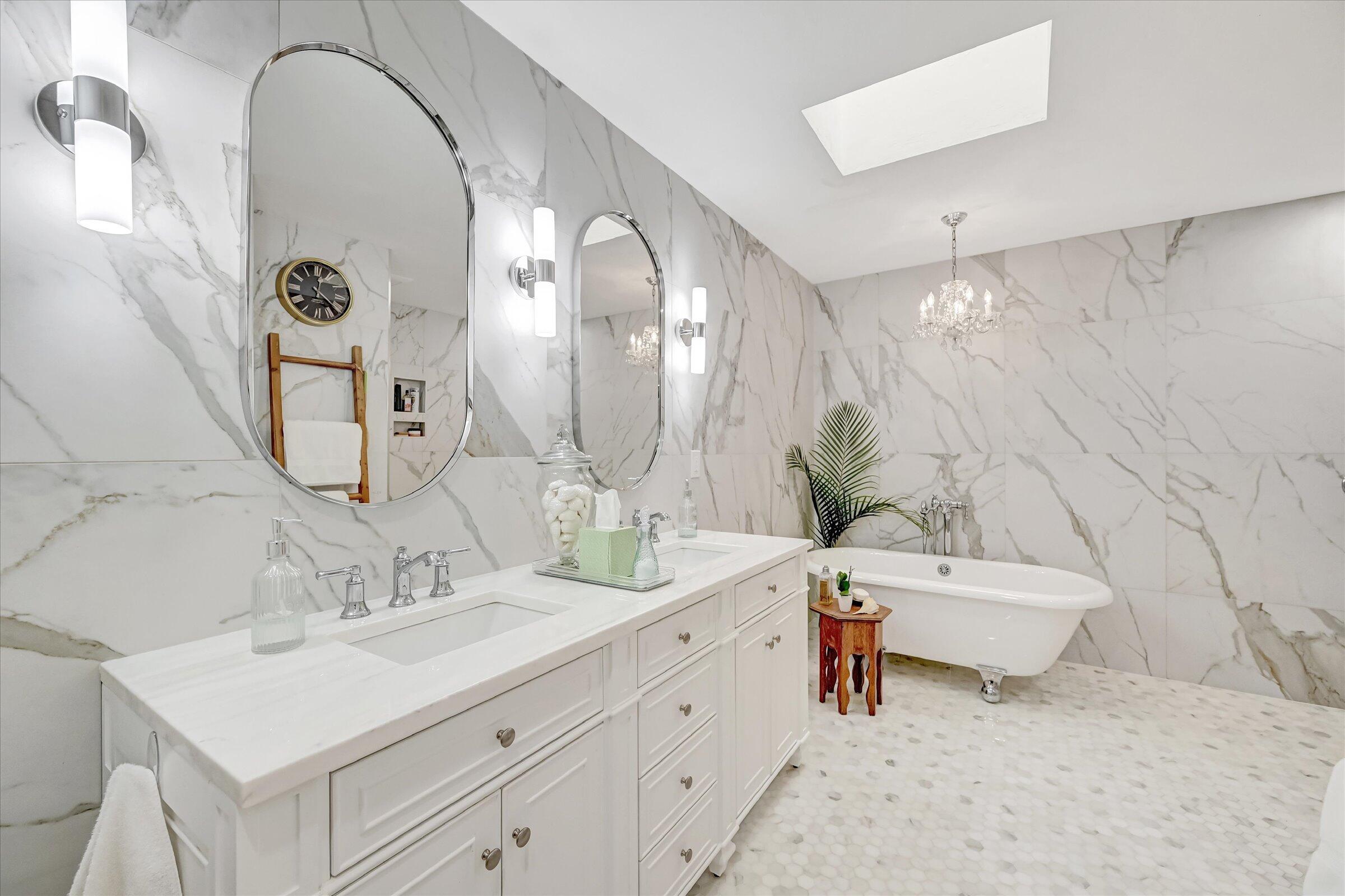 535 Augusta Boulevard, Unit 4 Naples, FL 34113 - Photo 32 of 44 a spacious bathroom with a double vanity sink mirror and