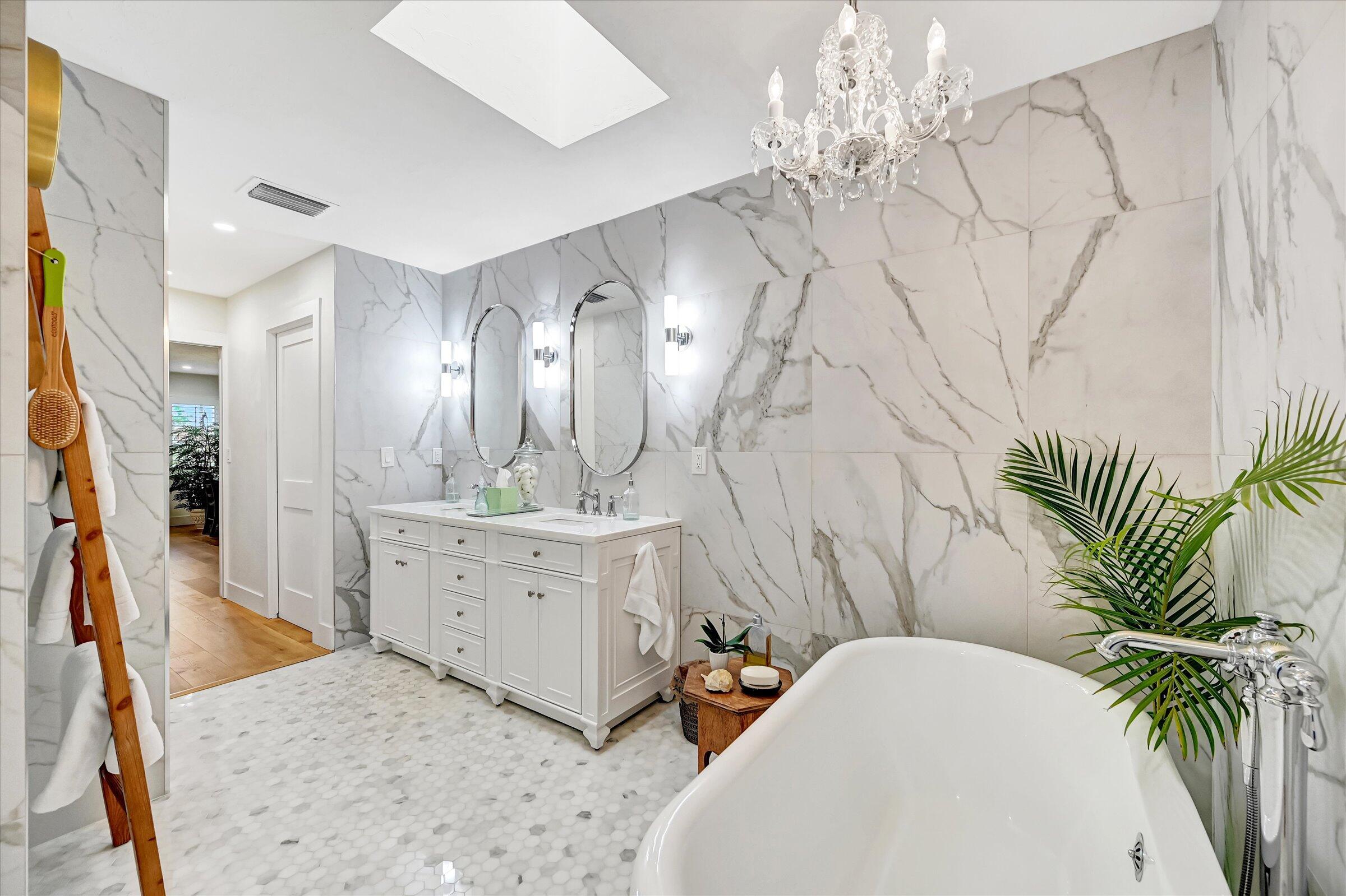 535 Augusta Boulevard, Unit 4 Naples, FL 34113 - Photo 34 of 44 a spacious bathroom with a double vanity sink and a mirror