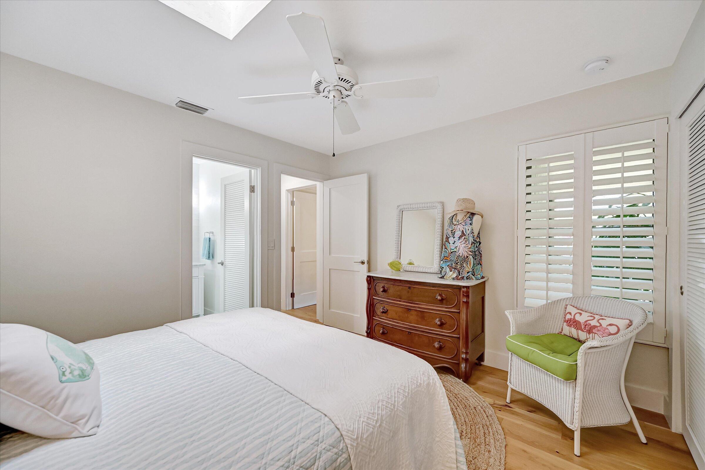 535 Augusta Boulevard, Unit 4 Naples, FL 34113 - Photo 37 of 44 a bedroom with a bed and a chandelier