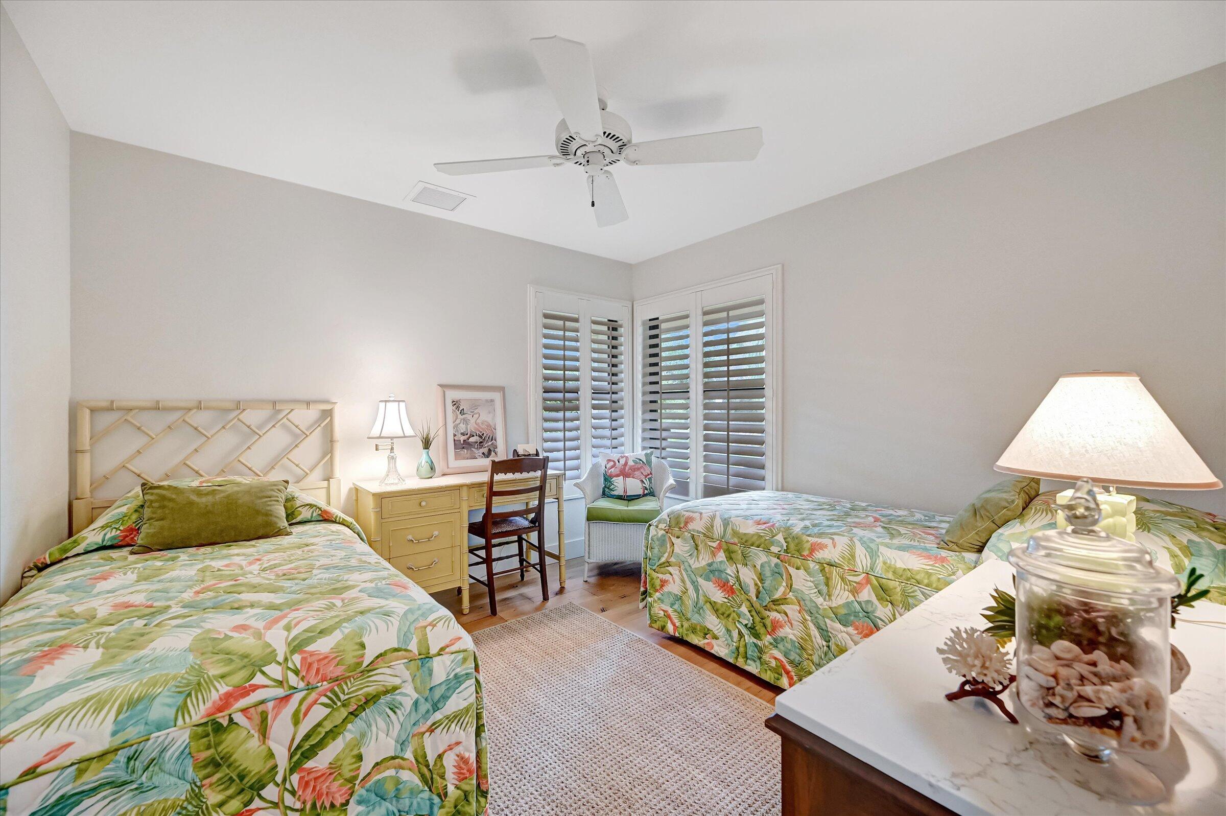 535 Augusta Boulevard, Unit 4 Naples, FL 34113 - Photo 39 of 44 a bedroom with a bed and a table in it