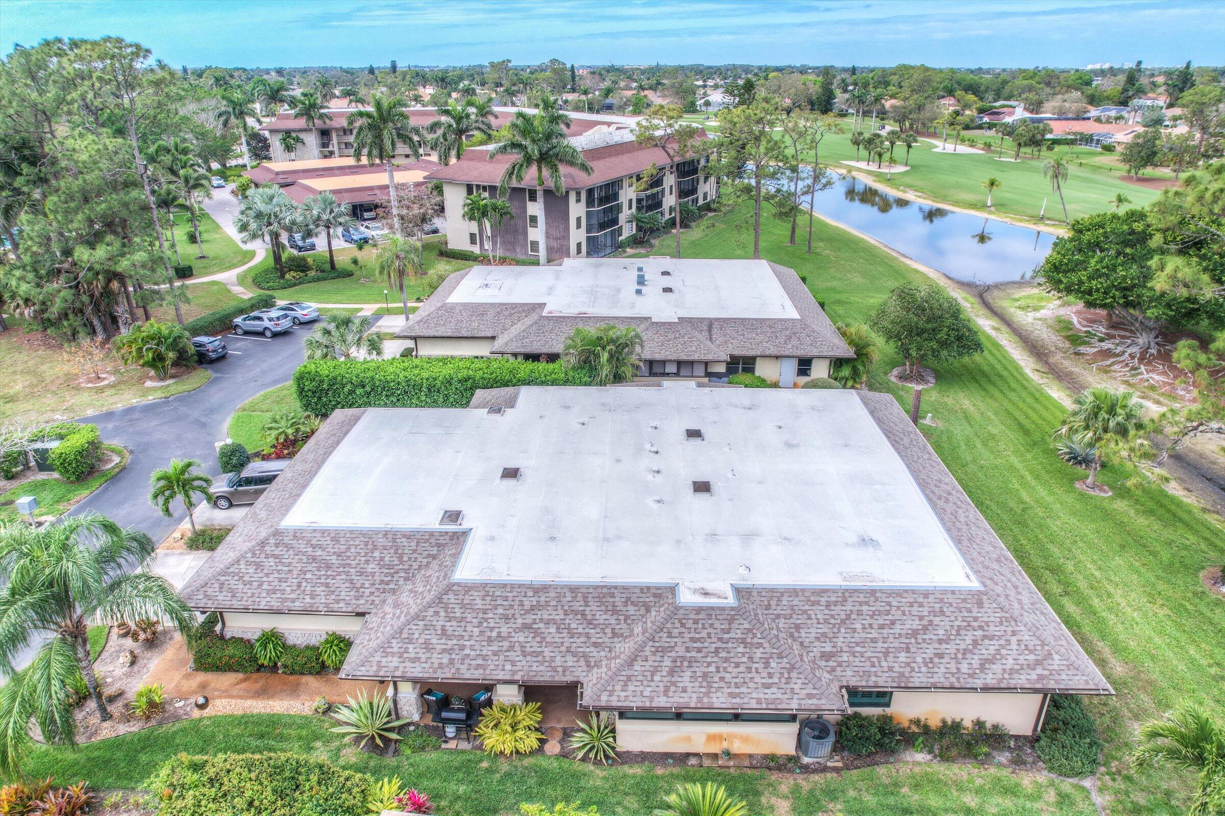 535 Augusta Boulevard, Unit 4 Naples, FL 34113 - Photo 43 of 44 an aerial view of multiple houses with a yard