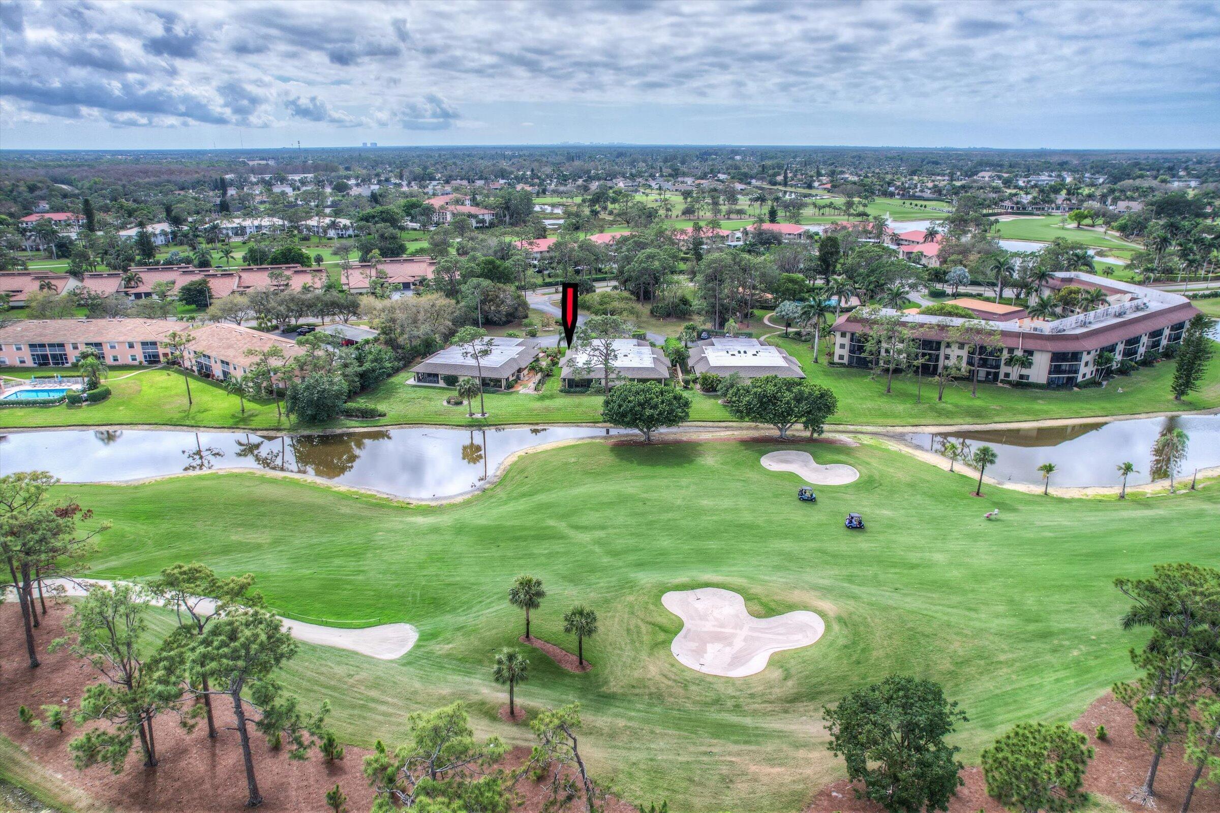 535 Augusta Boulevard, Unit 4 Naples, FL 34113 - Photo 44 of 44 an aerial view of residential houses with outdoor space and trees