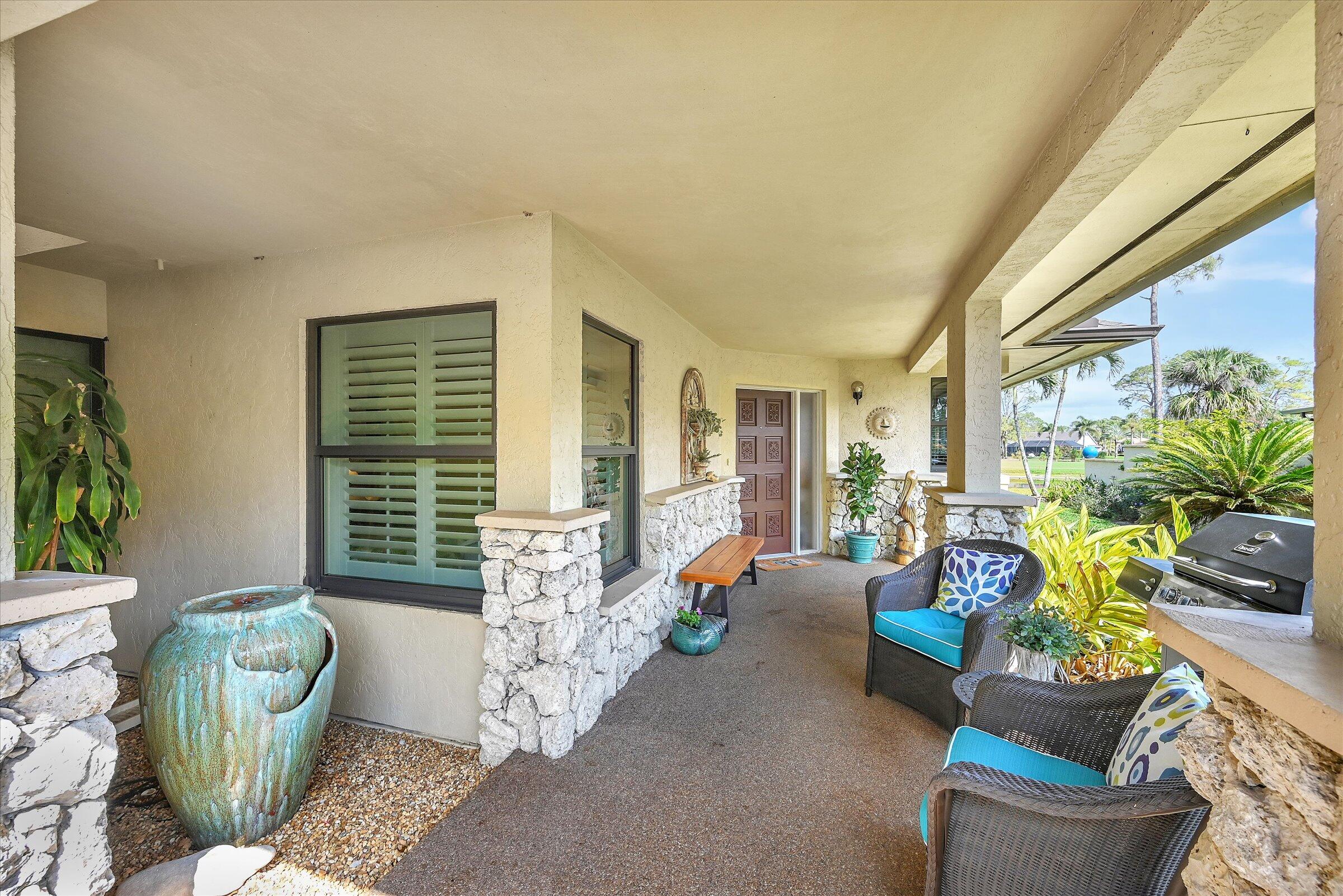 535 Augusta Boulevard, Unit 4 Naples, FL 34113 - Photo 6 of 44 a living room with furniture and a potted plant