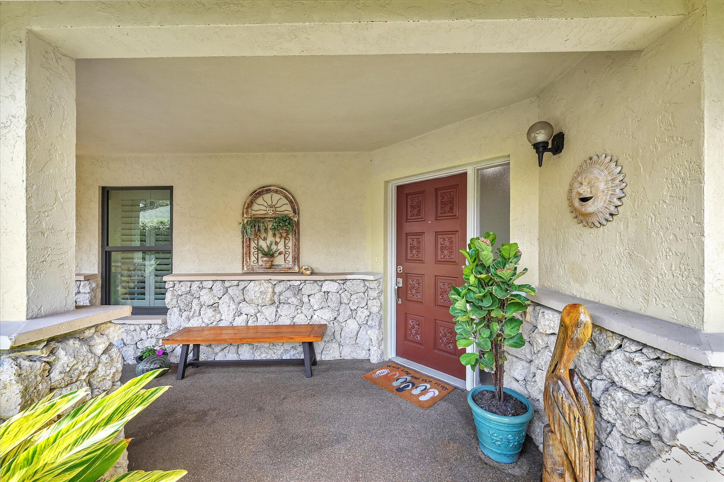535 Augusta Boulevard, Unit 4 Naples, FL 34113 - Photo 8 of 44 a living room with a potted plant and a potted plant