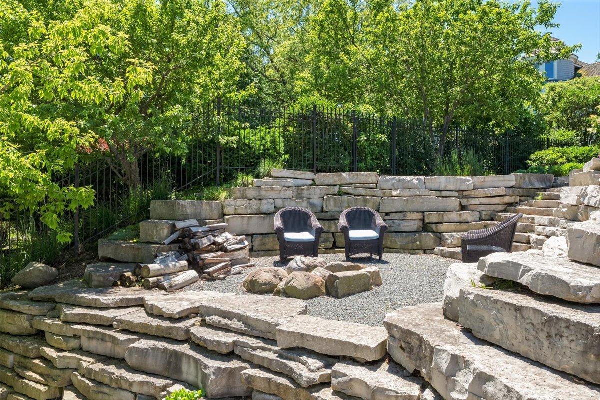 319 Sheridan Road Winnetka, IL 60093 - Photo 71 of 81 a view of a patio with couches table and chairs under an umbrella