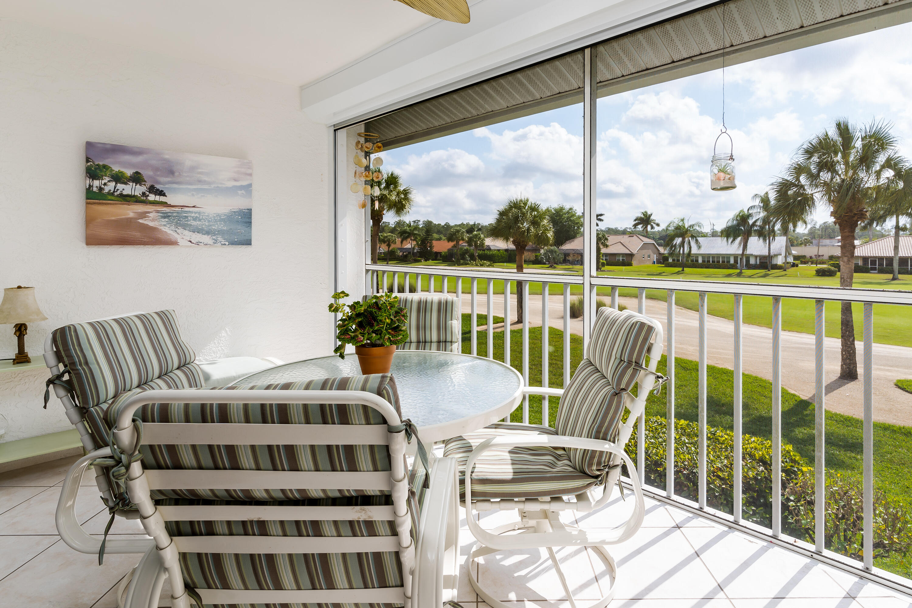 5936 Cranbrook Way, Unit B206 Naples, FL 34112 - Photo 2 of 2 a balcony view with a seating space and a floor to ceiling window