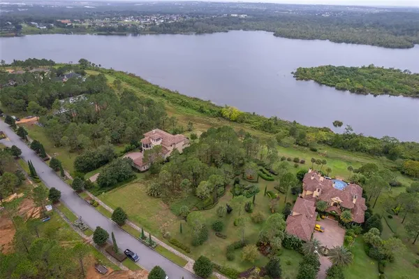 an aerial view of a house with a yard